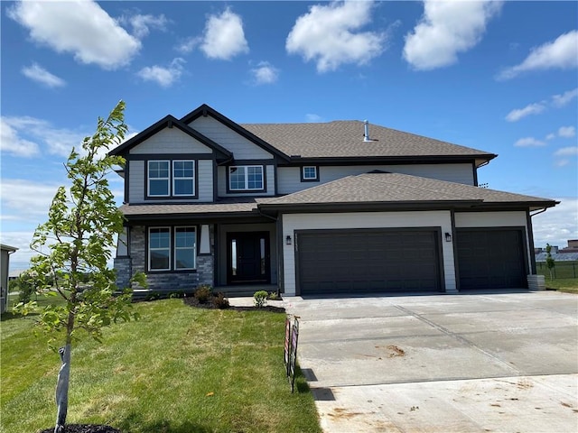 17133 W 164th Ter, Olathe, KS 66062 - view of front of home with a garage, driveway, a front lawn, and a shingled roof