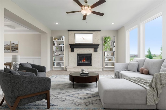 17133 W 164th Ter, Olathe, KS 66062 - carpeted living area with ceiling fan, a decorative wall, a large fireplace, crown molding, and recessed lighting