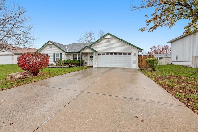 view of front of property featuring a front yard and a garage