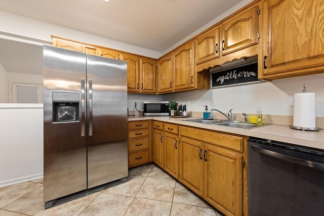 kitchen featuring light tile patterned flooring, stainless steel appliances, and sink