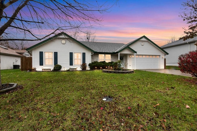 ranch-style house with a yard and a garage