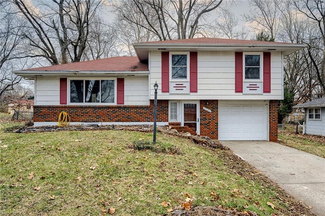 tri-level home featuring a garage and a front lawn