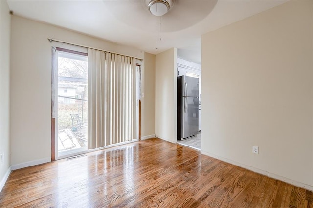 empty room featuring ceiling fan and light hardwood / wood-style flooring