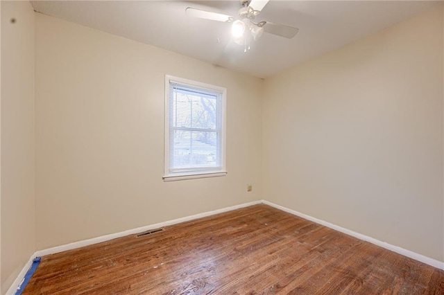 unfurnished room with ceiling fan and hardwood / wood-style flooring