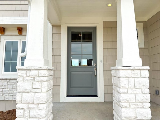 view of exterior entry with covered porch