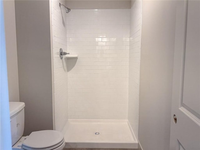 full bathroom featuring toilet and a shower stall