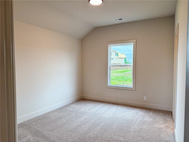additional living space featuring carpet floors, baseboards, and vaulted ceiling