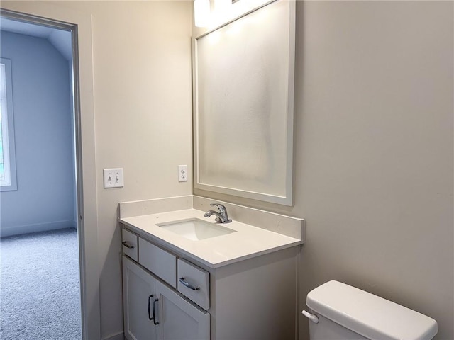 half bath featuring toilet and vanity