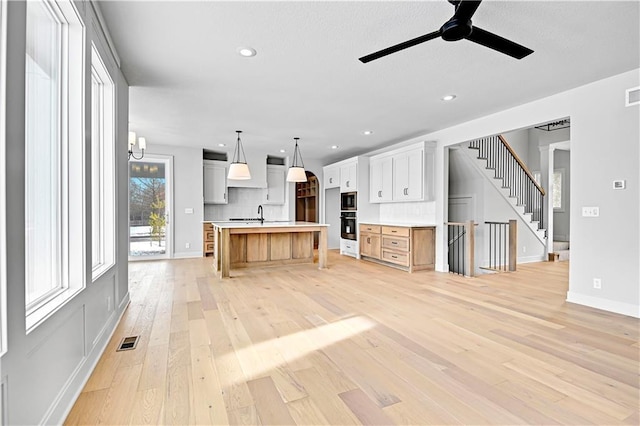 kitchen featuring ceiling fan, light wood-style flooring, light countertops, white cabinets, and recessed lighting