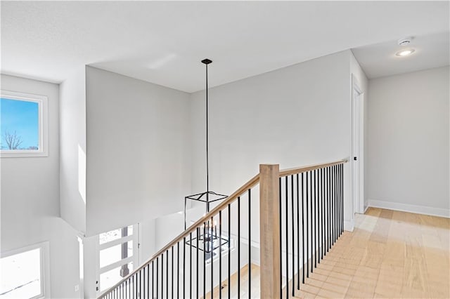 corridor with plenty of natural light, an upstairs landing, and recessed lighting