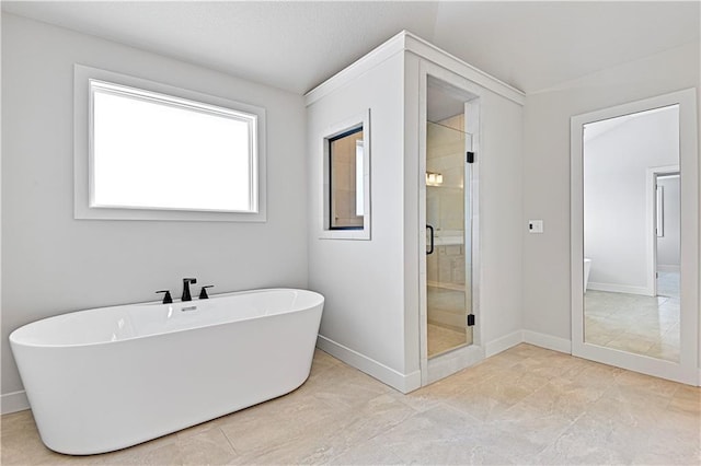 full bathroom with a shower stall, a soaking tub, baseboards, and tile patterned floors