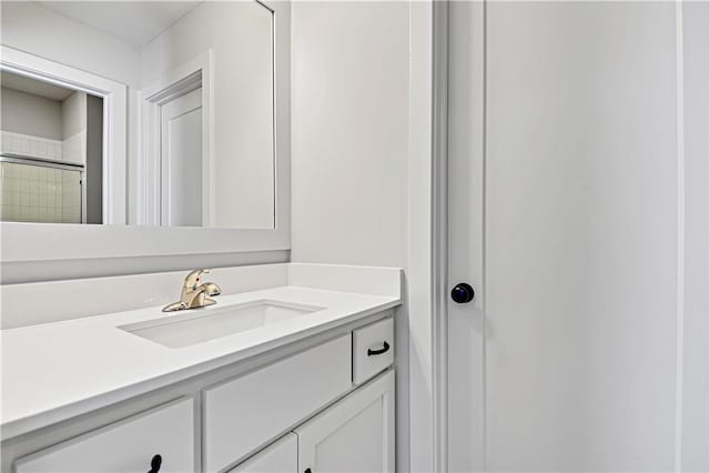 bathroom with vanity and a shower with door
