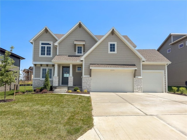 22070 W 100th Ter, Lenexa, KS 66220 - craftsman-style house featuring stone siding, concrete driveway, a front lawn, and an attached garage