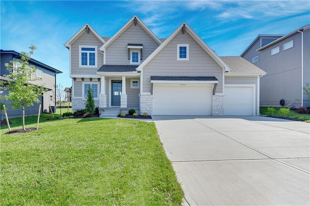 22070 W 100th Ter, Lenexa, KS 66220 - craftsman house with stone siding, driveway, a front lawn, and an attached garage