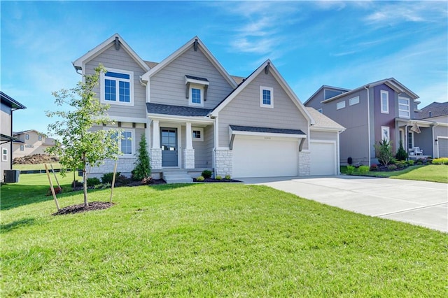 22070 W 100th Ter, Lenexa, KS 66220 - craftsman-style home with concrete driveway, a front lawn, an attached garage, and stone siding