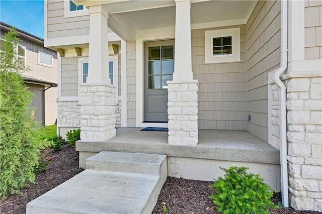 22070 W 100th Ter, Lenexa, KS 66220 - doorway to property with covered porch and stone siding