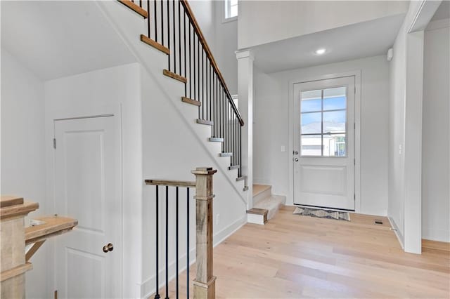 22070 W 100th Ter, Lenexa, KS 66220 - entrance foyer with light wood-style flooring, healthy amount of natural light, and stairs