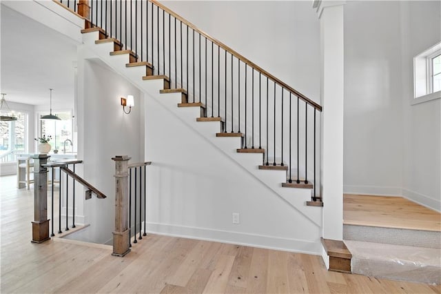 22070 W 100th Ter, Lenexa, KS 66220 - stairway with wood finished floors and a towering ceiling