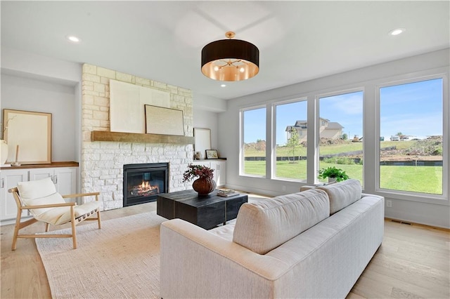 22070 W 100th Ter, Lenexa, KS 66220 - living area featuring light wood-style flooring, a fireplace, and recessed lighting