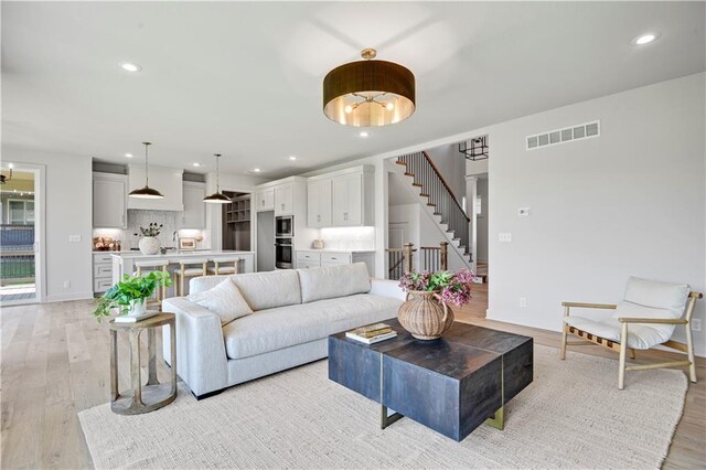 22070 W 100th Ter, Lenexa, KS 66220 - living room with stairway, light wood-type flooring, and recessed lighting