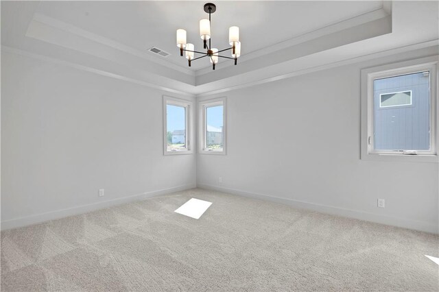 22070 W 100th Ter, Lenexa, KS 66220 - spare room with a tray ceiling, a chandelier, crown molding, and carpet floors