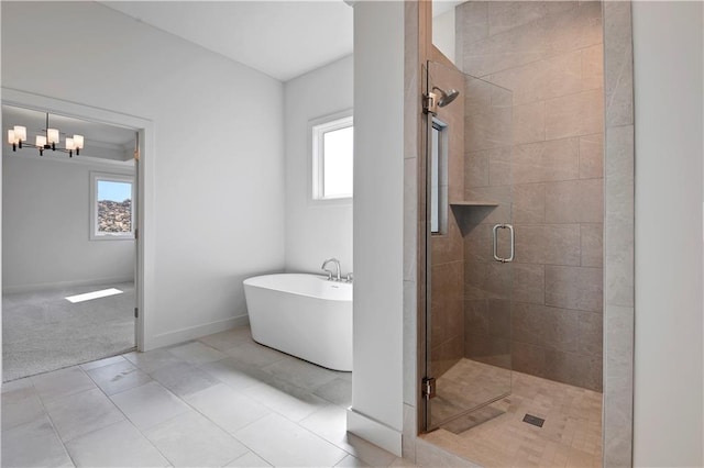 22070 W 100th Ter, Lenexa, KS 66220 - bathroom featuring a freestanding bath, healthy amount of natural light, a shower stall, and a chandelier