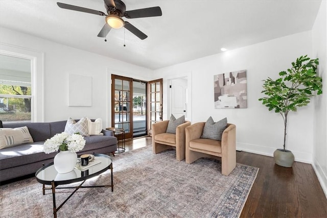 living room featuring wood-type flooring and ceiling fan