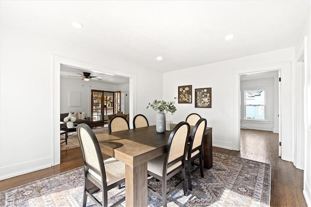 dining room with ceiling fan and dark hardwood / wood-style floors