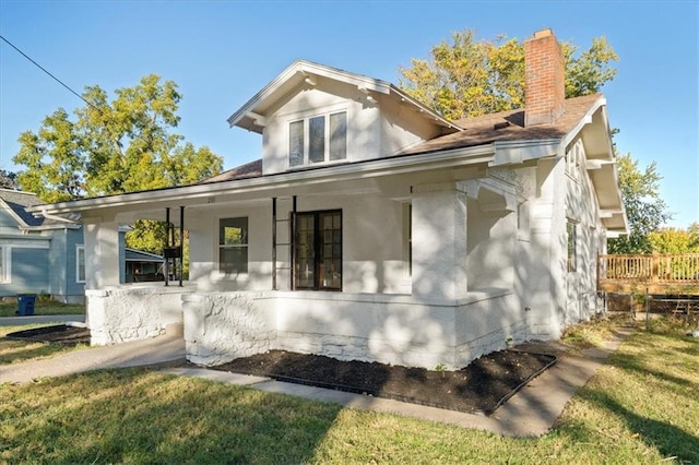 rear view of house featuring a lawn