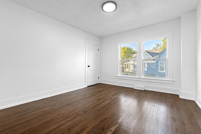 empty room featuring dark hardwood / wood-style flooring