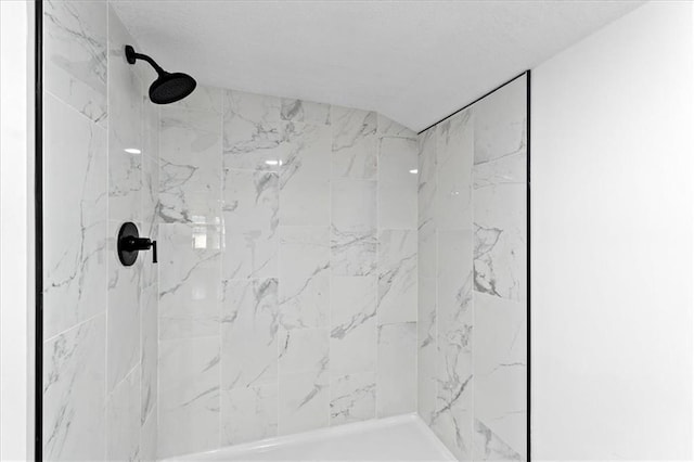 bathroom with tiled shower