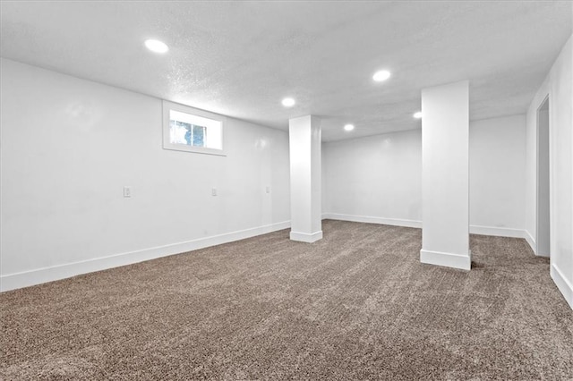 basement with a textured ceiling and carpet