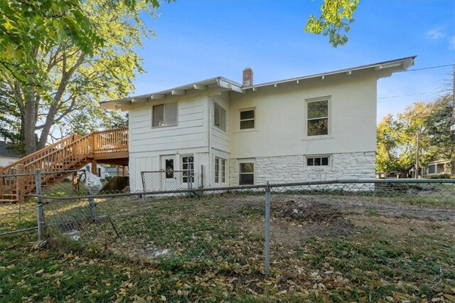 back of property with a wooden deck