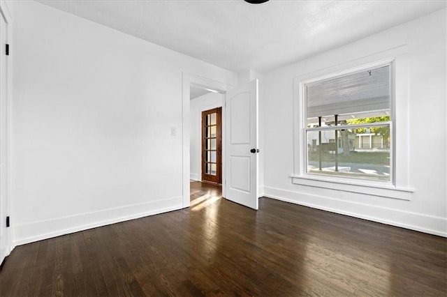 spare room with dark hardwood / wood-style floors