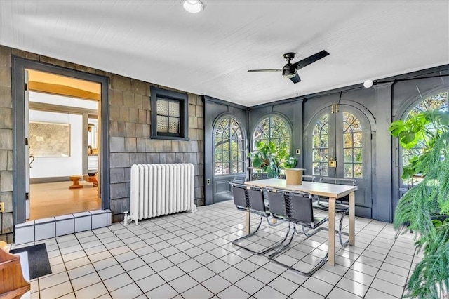 view of patio featuring french doors, radiator heating unit, and ceiling fan