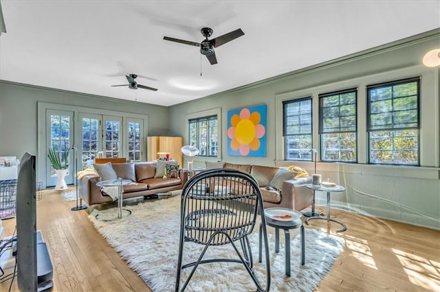 interior space with ornamental molding, light hardwood / wood-style flooring, and ceiling fan