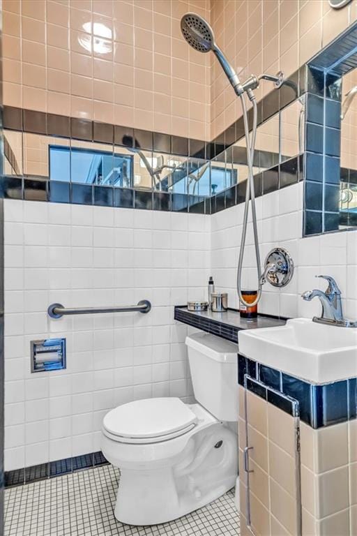 bathroom with toilet, tile walls, and tile patterned flooring