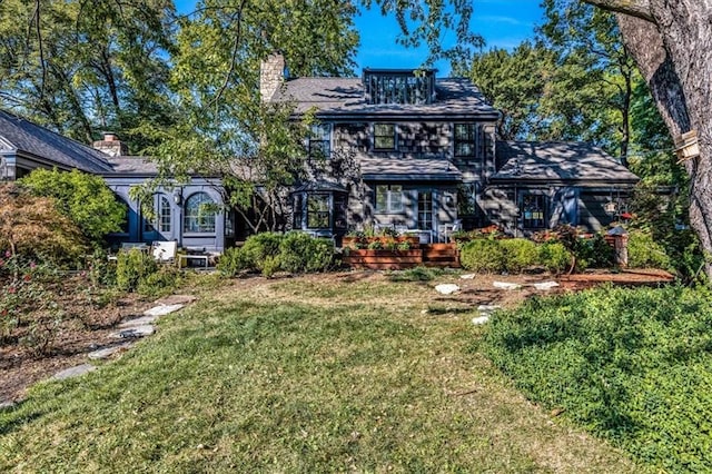 rear view of property featuring a yard