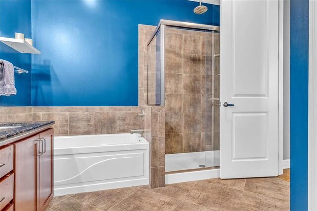 bathroom featuring vanity and shower with separate bathtub