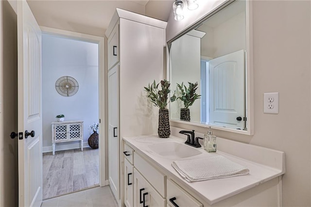 bathroom with hardwood / wood-style floors and vanity