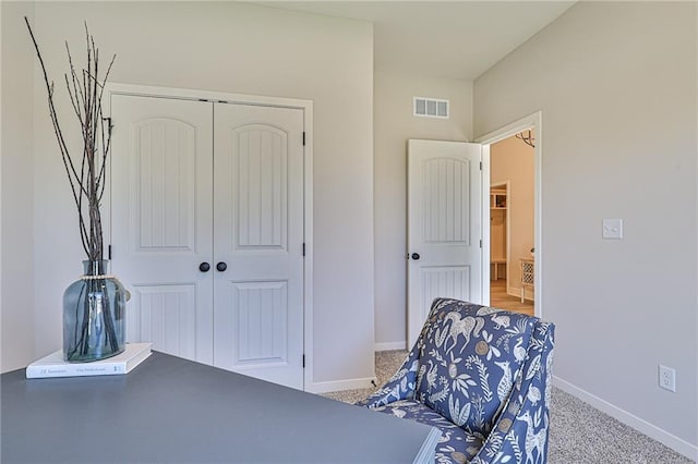 interior space with light carpet and a closet