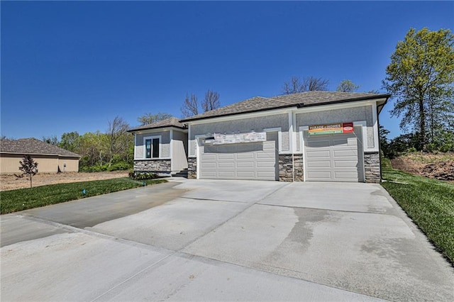845 Willow Tree Ct, Higginsville, MO 64037 - view of front of property with stone siding, driveway, a garage, and a front lawn