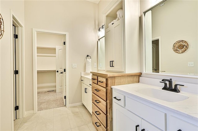 845 Willow Tree Ct, Higginsville, MO 64037 - full bathroom with vanity, a walk in closet, tile patterned flooring, and baseboards