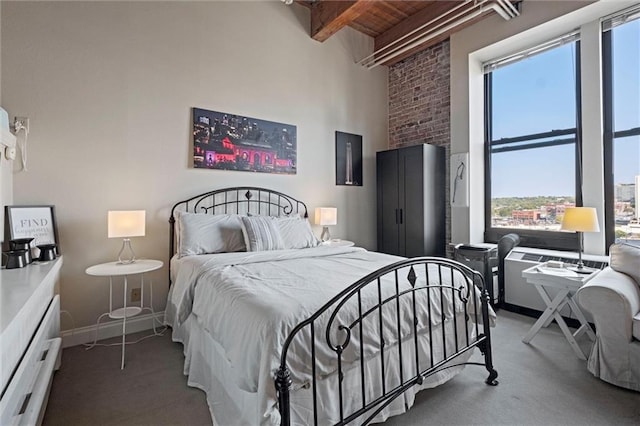 bedroom with carpet floors, wooden ceiling, beamed ceiling, and baseboards