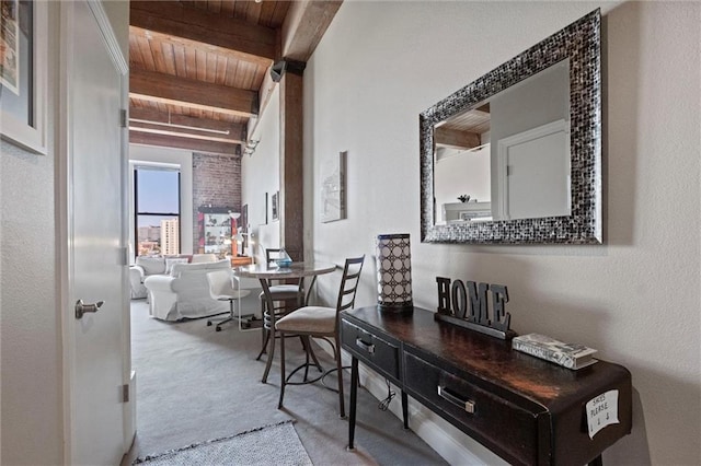 hallway with wooden ceiling, carpet flooring, and beam ceiling