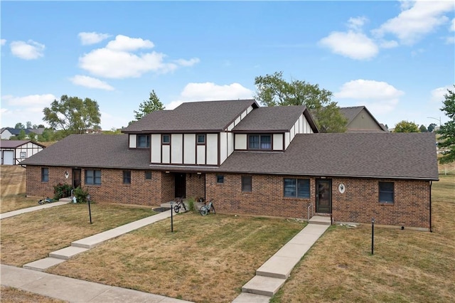 tudor house featuring a front lawn