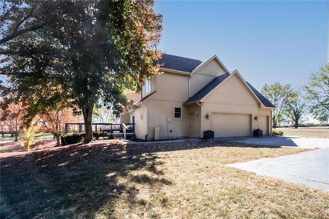 view of side of property with a lawn and a garage