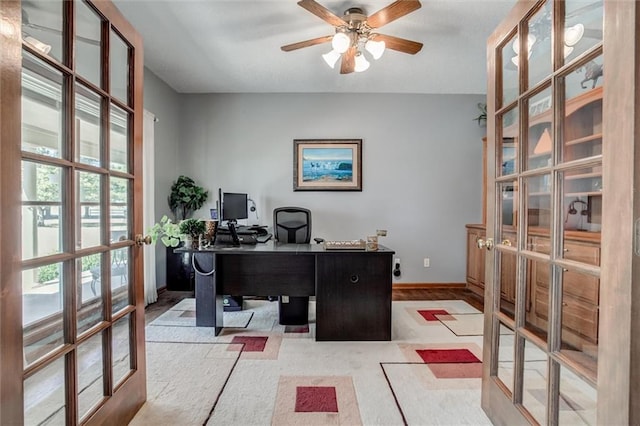 office with french doors and ceiling fan