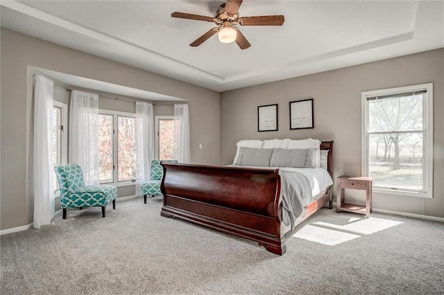 carpeted bedroom with multiple windows and ceiling fan