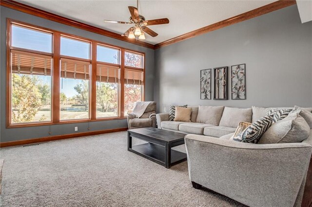 living room featuring ornamental molding, carpet floors, and ceiling fan